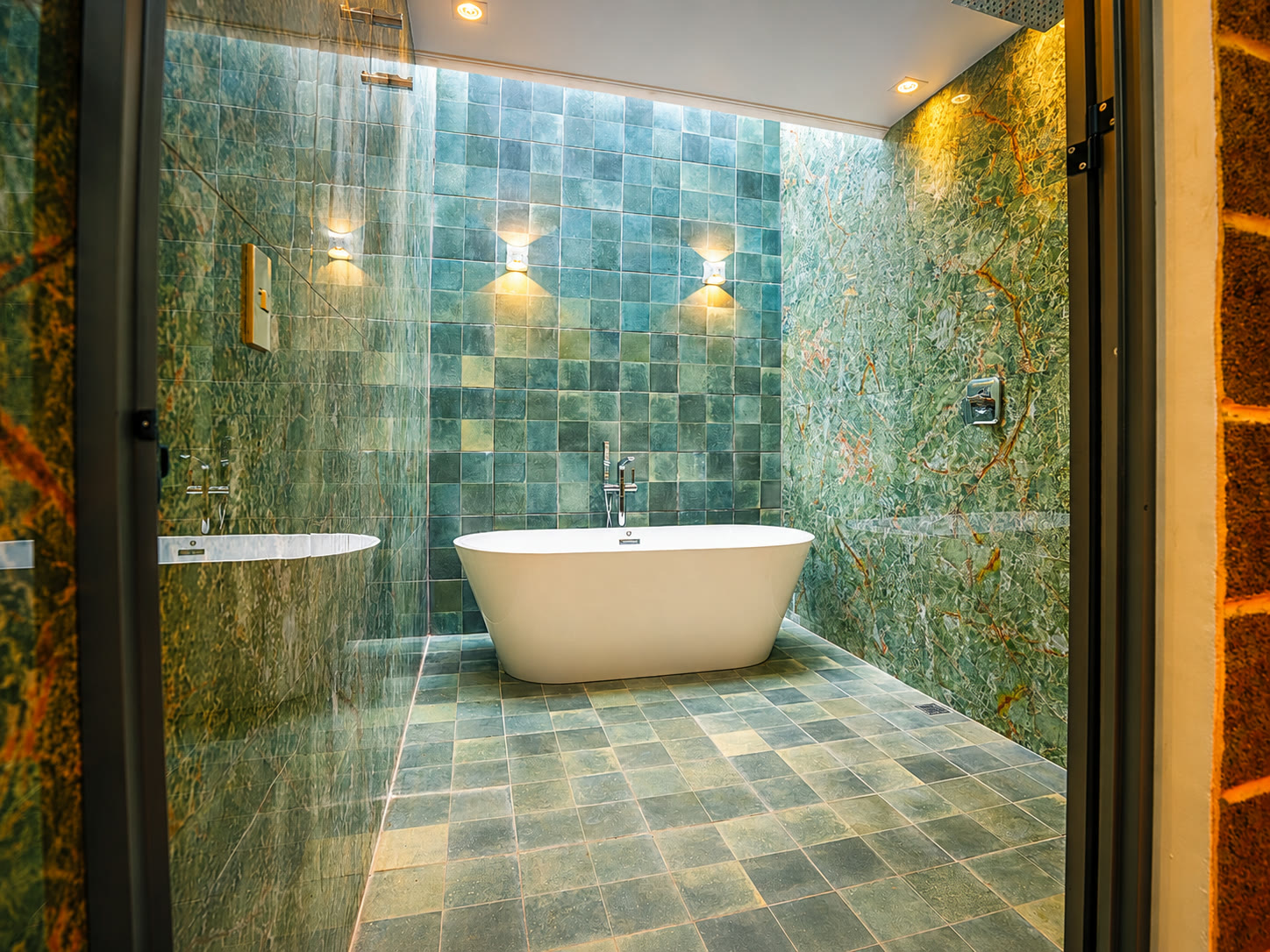 A private glamping bathroom with a freestanding tub and stone wall finishes