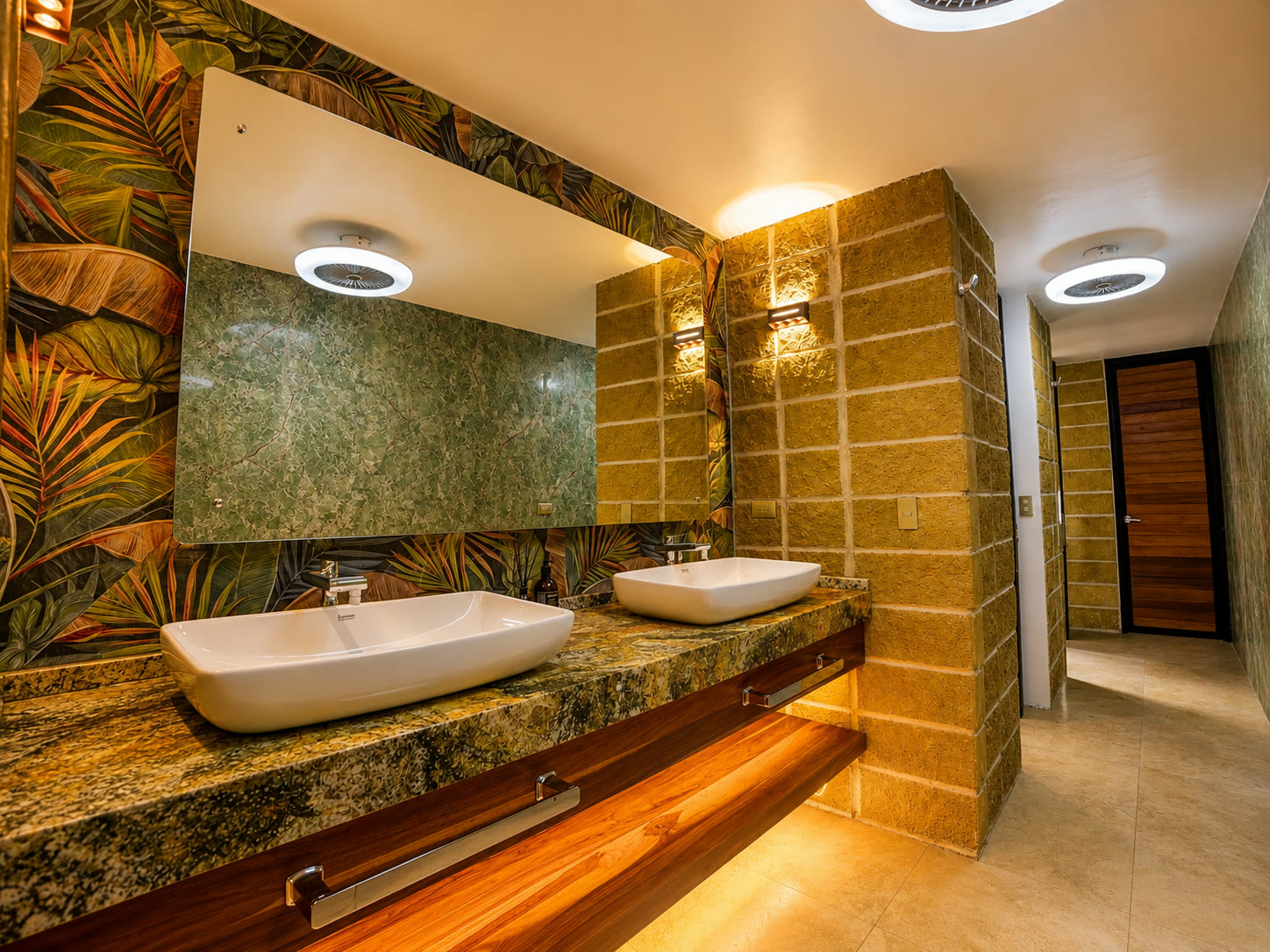 A spacious private glamping bathroom with two vanity mirrors, stone finishes and warm lighting